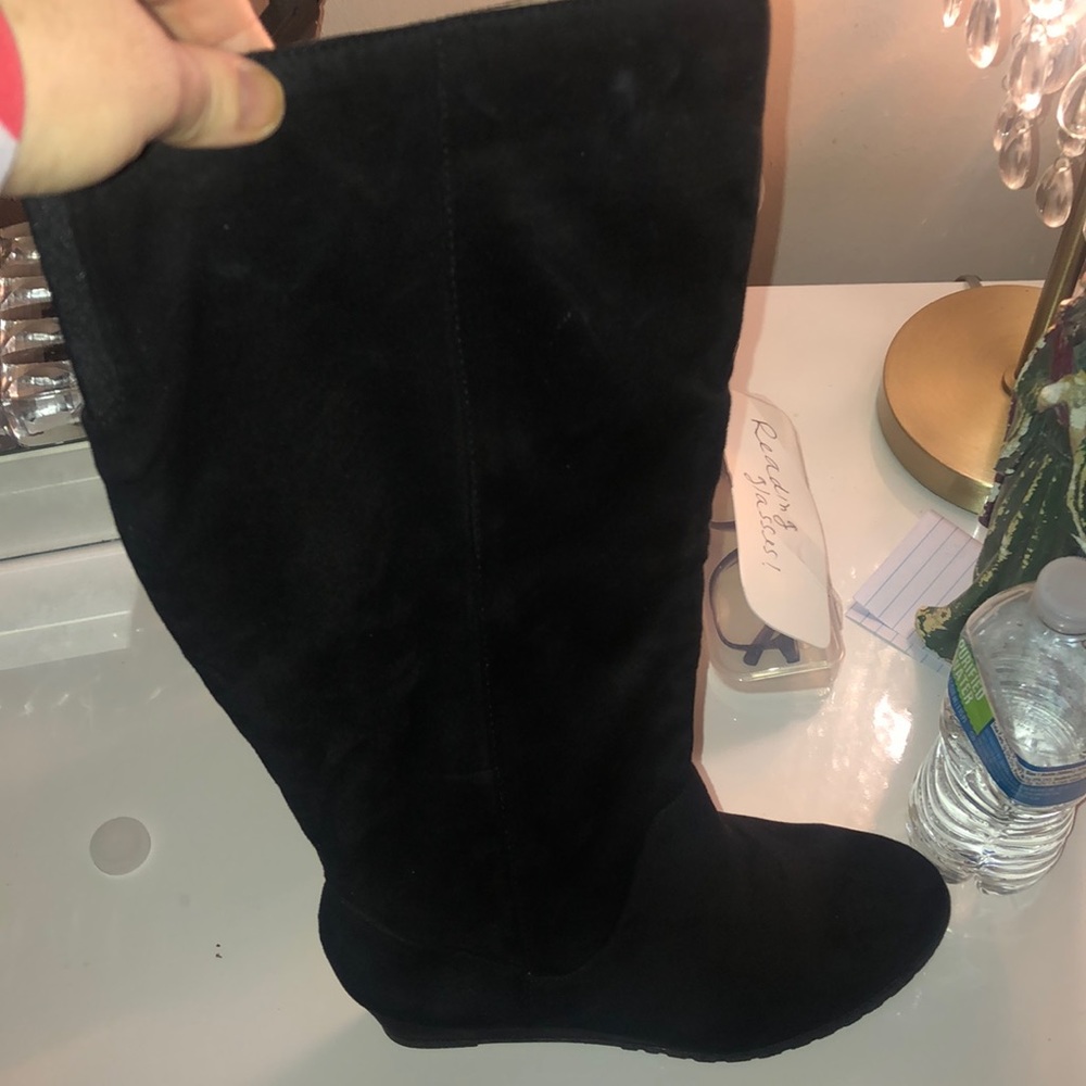 Mid thigh suede wedge boots.